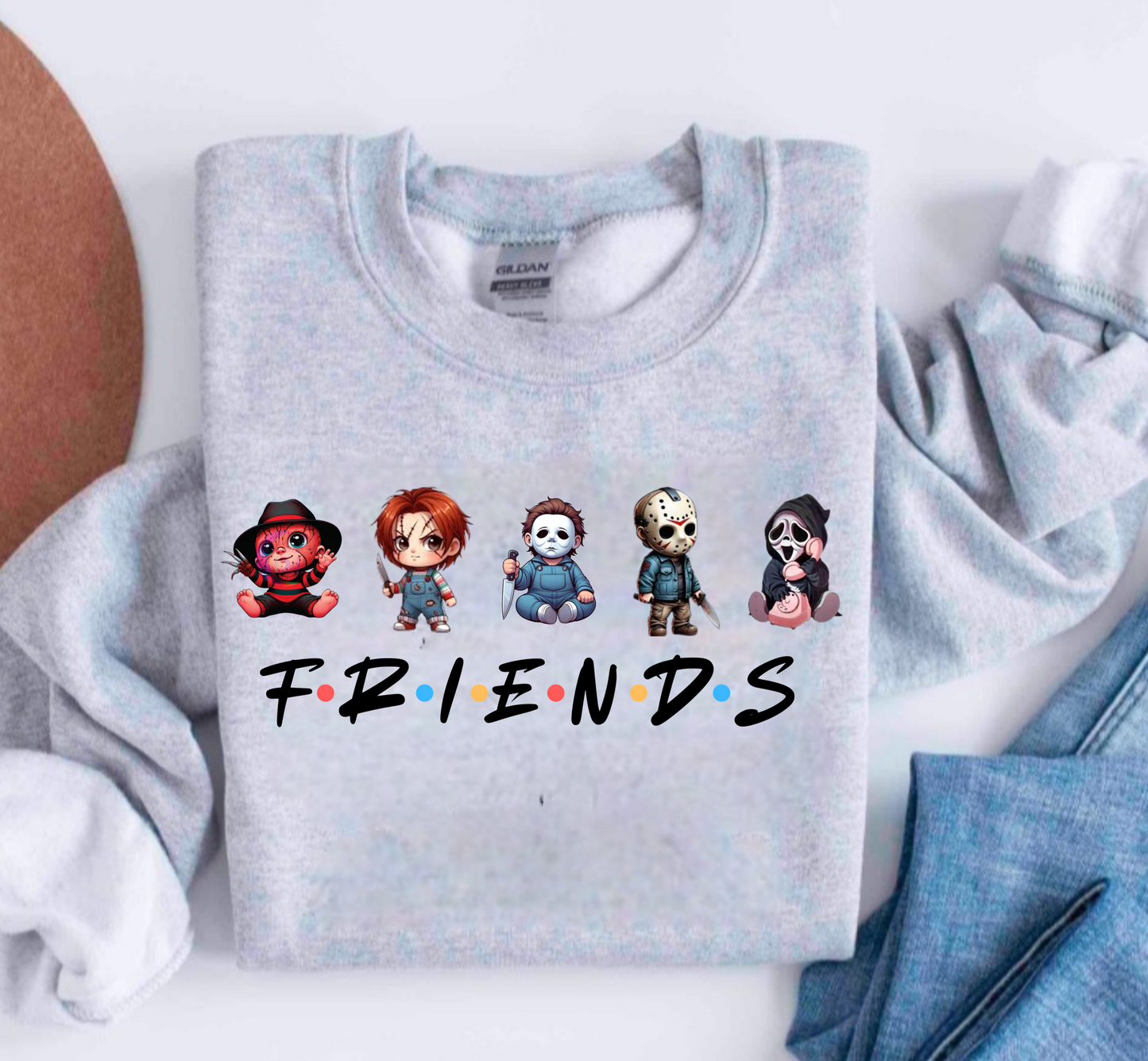 Grey Sweater featuring chibi characters of Freddy Kreuger, Chucky, Michael Myers, Jason Voorhees and Ghostface. 